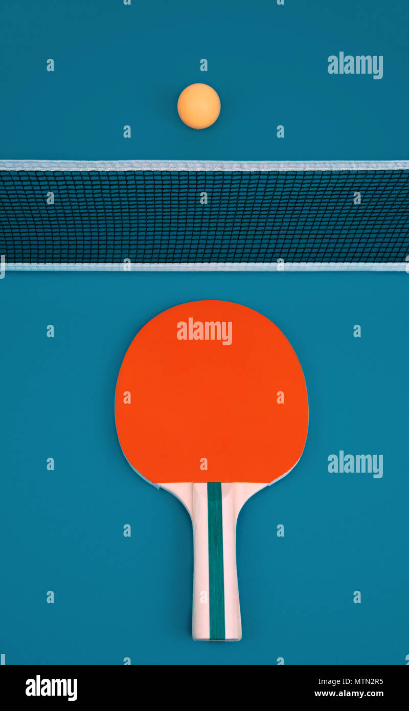 Table tennis or ping pong rackets and ball on a blue table Stock Photo