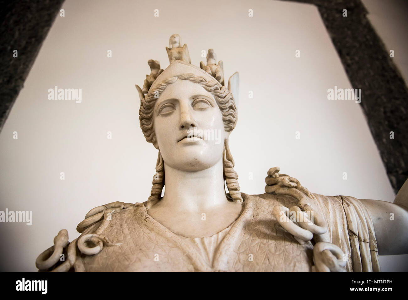 A statue Athena or Athene, the ancient Greek goddess, exhibited inside the Naples Archaelogical Museum in Italy. Stock Photo