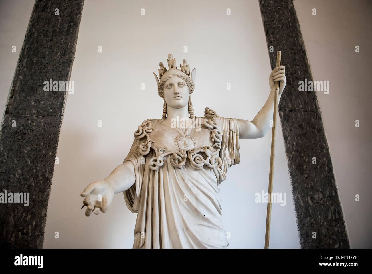 A statue Athena or Athene, the ancient Greek goddess, exhibited inside the Naples Archaelogical Museum in Italy. Stock Photo