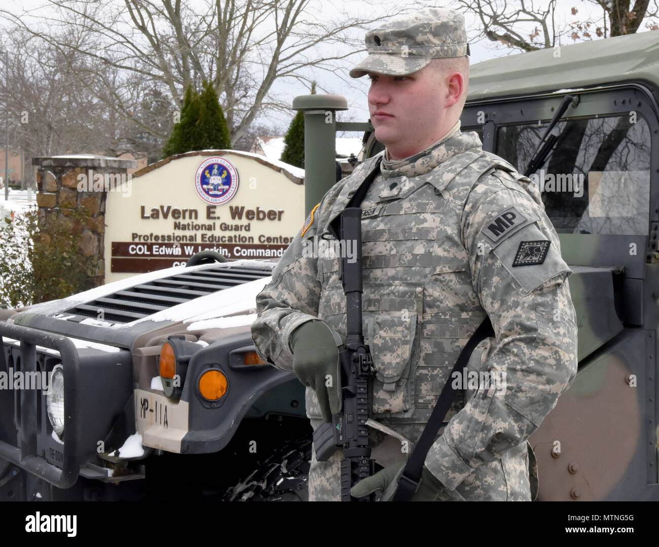 Spec. Johnathon Christensen, a Military Police Officer assigned to the 216th Military Police Company, 871st Troop Command Battalion, 87th Troop Command Brigade, Arkansas National Guard, stands guard at a security checkpoint at the 2017 National Guard Senior Commanders Forum held at the Professional Education Center on Robinson Maneuver Training Center in North Little Rock, Arkansas, on Friday. Stock Photo