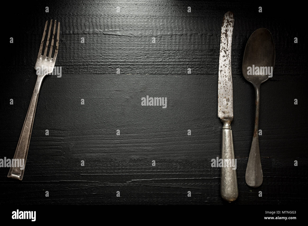 Old Rustic Cutlery on Dark Wooden Background. Kitchen and Food Concept. Stock Photo