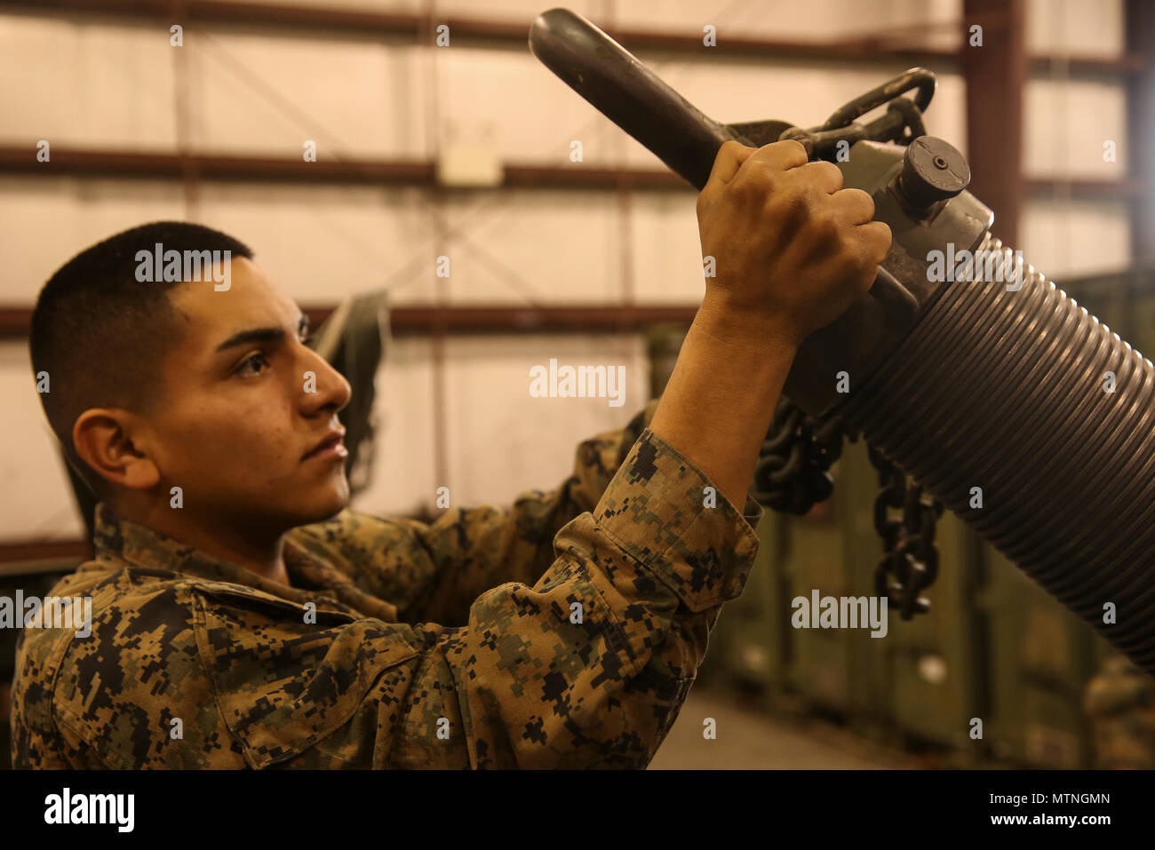 Private First Class Jorge Amaya prepares to take off the bore saftey for  the 120 mm mortar during Reconnaissance, Selection and Occupying Position  training at Camp Lejeune, N.C., Jan. 6. Marines with