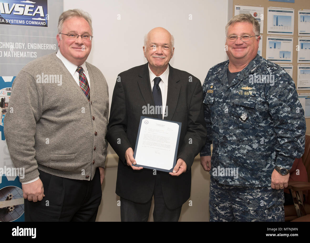 Naval Surface Warfare Center Panama City Division (NSWC PCD) Technical Director Ed Stewart, SES, (left) and NSWC PCD Commanding Officer Capt. Phillip E. Dawson (right), present Office of Research and Technology Applications (ORTA) Manager, Ed Linsemeyer (center), a Letter of Appreciation from Naval Sea Systems Command (NAVSEA) for his outstanding dedication to the Science, Technology, Engineering and Mathematics Program Jan. 9, 2017. Stock Photo