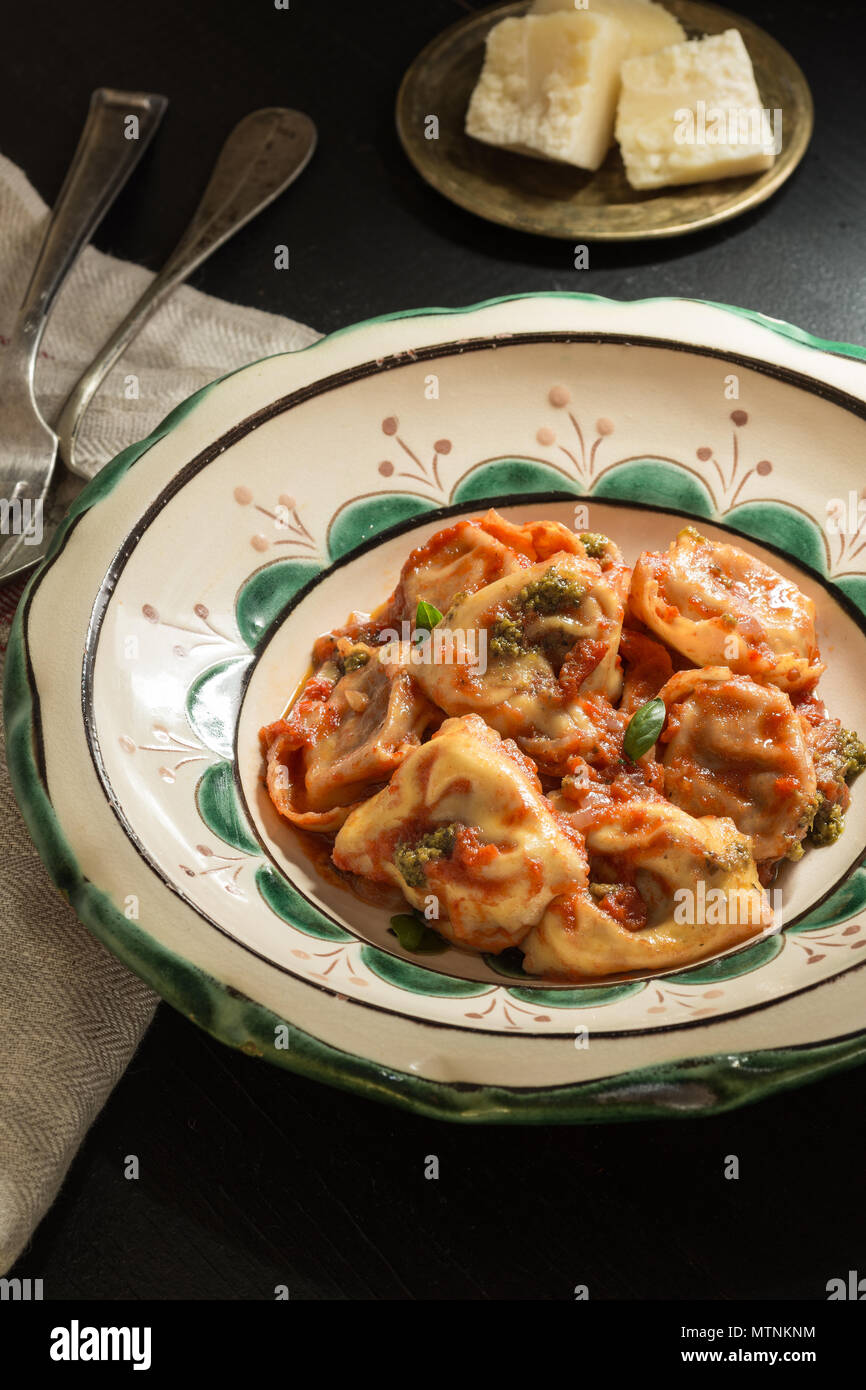 Fresh Homemade Tortellini with Tomato Sauce and Mozzarella Cheese on Rustic Plate Stock Photo