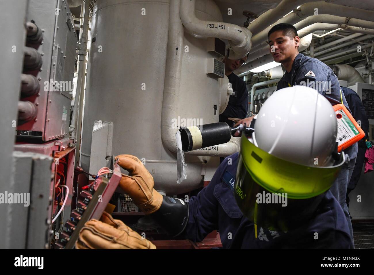170111-N-JI086-063 - MEDITERRANEAN SEA (Jan. 11, 2017) Electrician's Mate 1st Class Fernando Landeros, from Dallas, left, and Gas Turbine Systems Technician (Mechanical) 3rd Class Enrique Gonzalez, from San Bernardino, Calif., participate in an engineering training team evolution aboard the guided missile destroyer USS Porter (DDG 78), Jan. 11, 2017. Porter, forward-deployed to Rota, Spain, is conducting naval operations in the U.S. 6th Fleet area of operations in support of U.S. national security interests in Europe. (U.S. Navy photo by Mass Communication Specialist 3rd Class Ford Williams/Re Stock Photo