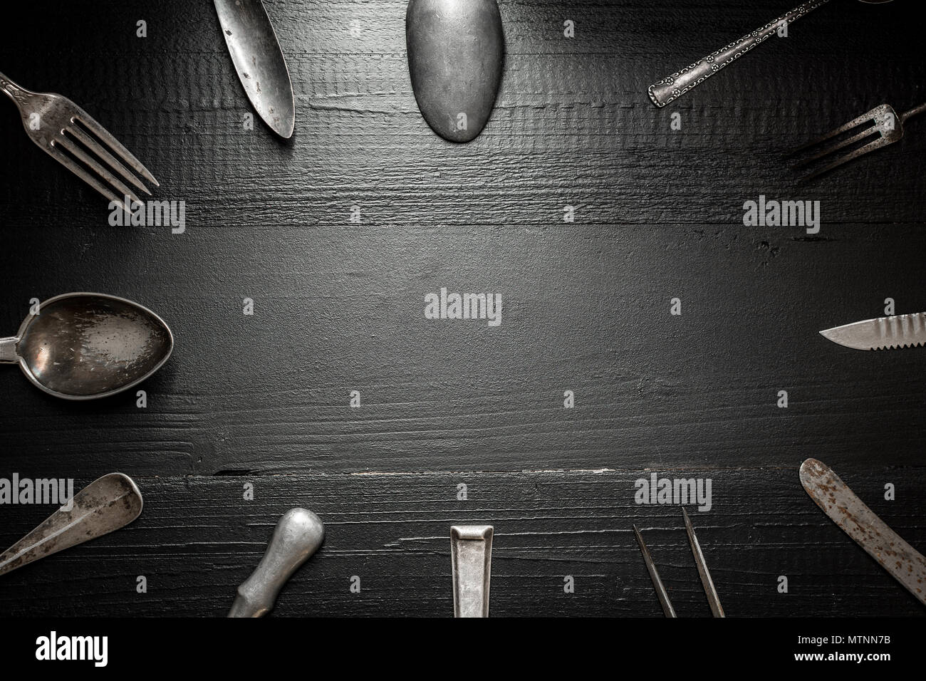 Rustic Silverware on Dark Wooden Background. Kitchen and Restaurant Concept. Stock Photo