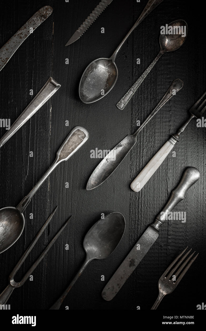 Rustic Silverware on Dark Wooden Background. Kitchen and Restaurant Concept. Stock Photo