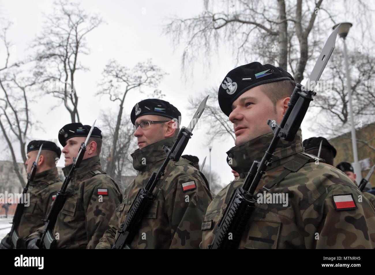 ZAGAN, Poland— Polish Soldiers stand at position of attention during a ceremony in celebration of Safe Poland day in Zagan, Poland, Jan. 14, at Gen. Stanislaw Macek Park. The celebration was an opportunity for the Polish citizens to welcome the Soldiers of 3rd Armored Brigade Combat Team, 4th Infantry Division. The 3-4 ABCT’s arrival marks the start of back-to-back rotations of armored brigades in Europe as part of Atlantic Resolve. This rotation will enhance deterrence capabilities in the region, improve the U.S. ability to respond to potential crises and defend allies and partners in the Eur Stock Photo