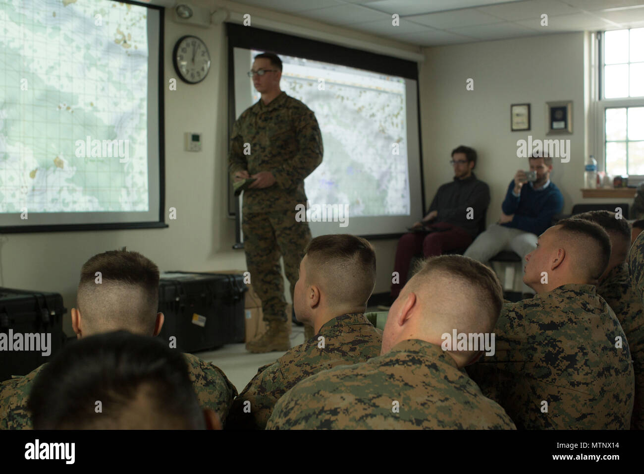 U.S. Marine Corps Sgt. Daniel A. Daly, center, a squad leader with Echo  Company, 2nd Battalion, 6th Marine Regiment, 2nd Marine Division (2d  MARDIV), debriefs Marines after utilizing Virtual Battlespace 3 (VBS