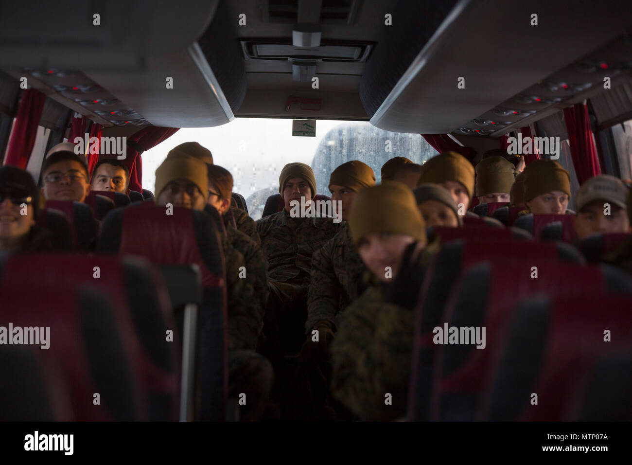 U.S. Marines board a bus on the tarmac headed to garrison at Vaernes Garnison, Norway, Jan. 16, 2017. The Marines with Black Sea Rotational Force 17.1 arrived at Vaernes Garnison early in the morning as part of Marine Rotational Force Europe 17.1. (U.S. Marine Corps photo by Lance Cpl. Victoria Ross) Stock Photo
