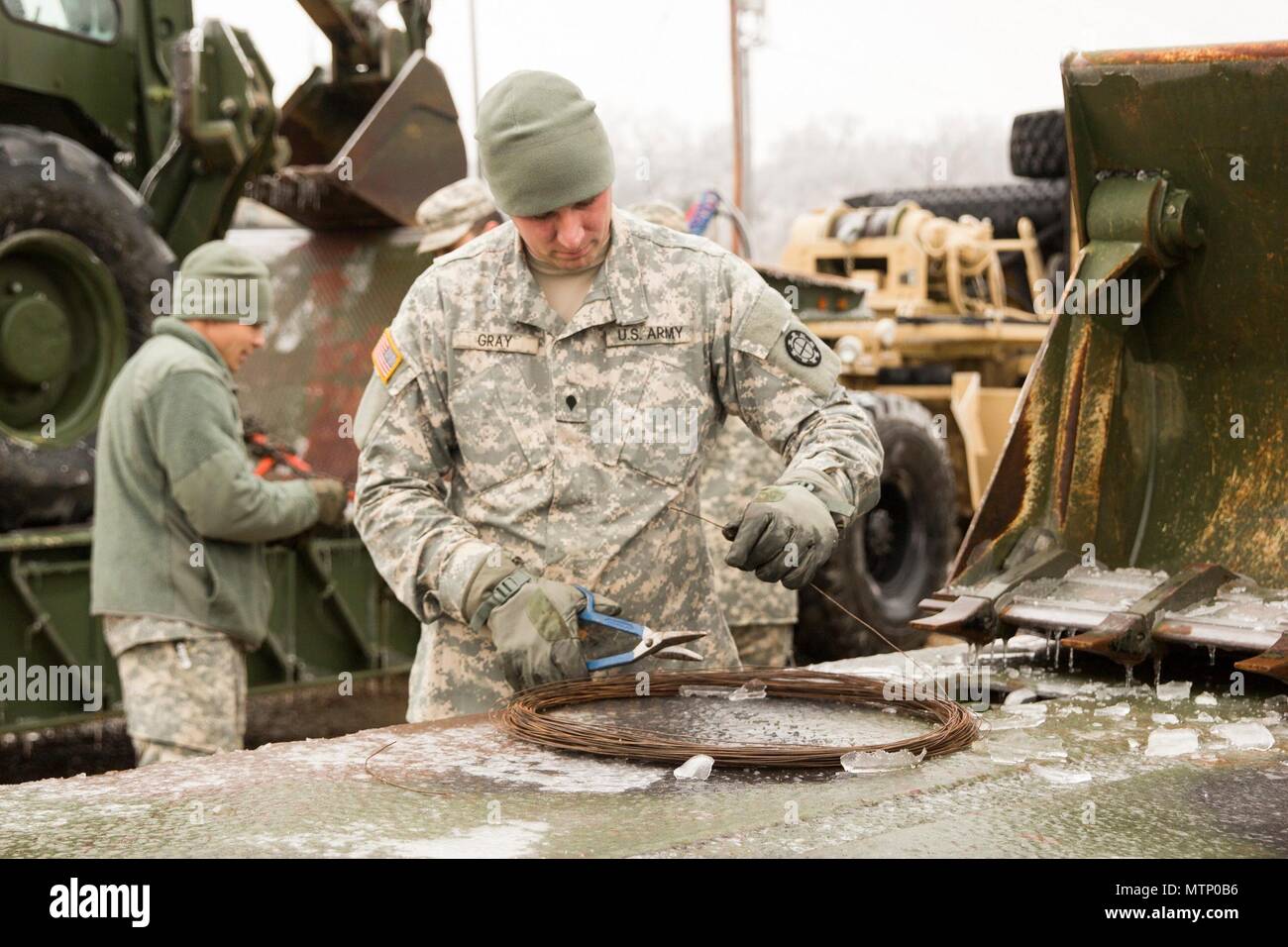 U.S. Army Spc. Derek Gray, 220th Engineer Company, prepares to wrap