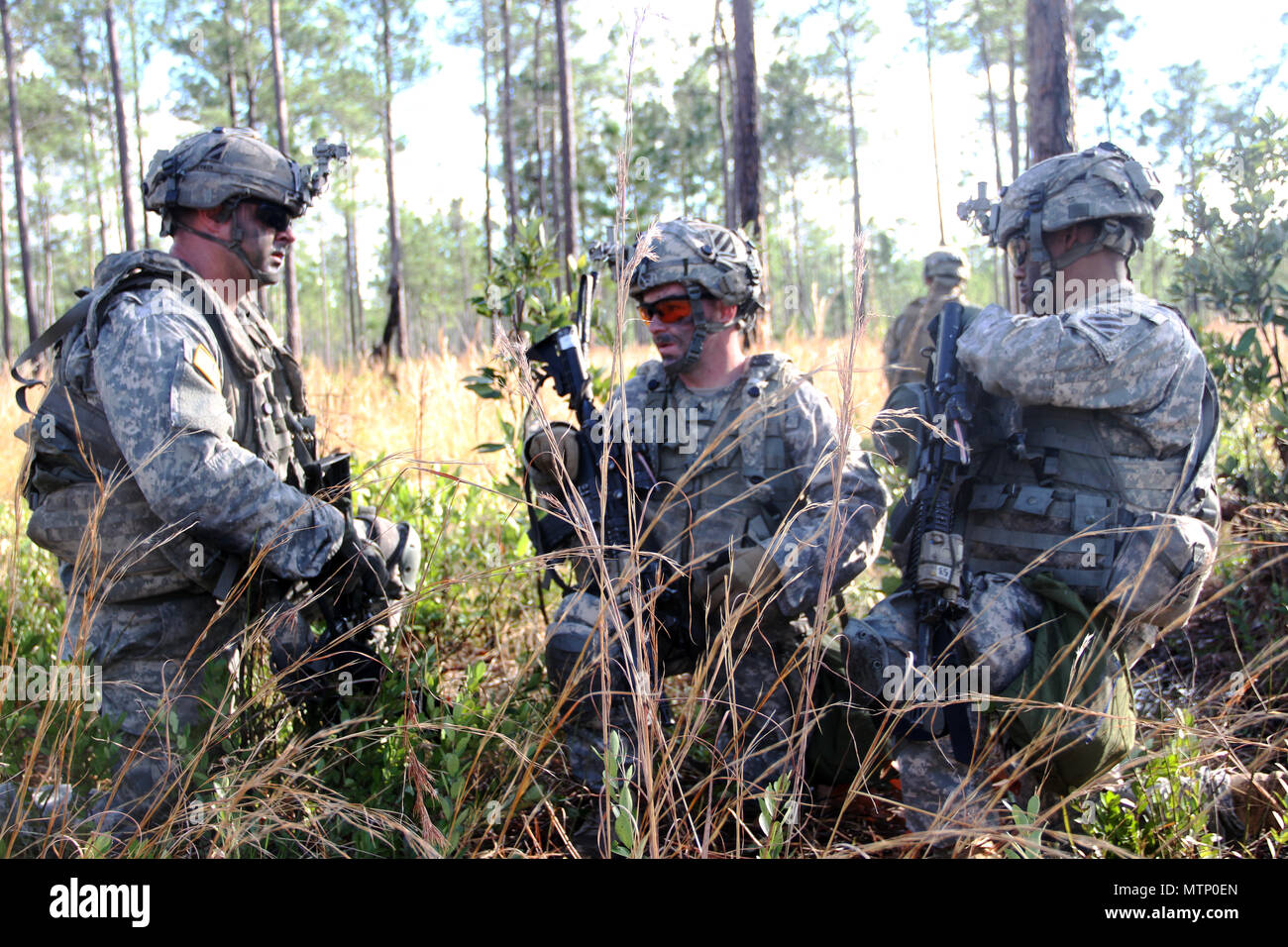 Infantrymen with Alpha Company 1st Battalion, 30th Infantry Regiment, 2nd Infantry Brigade Combat Team, 3rd Infantry Division, submit status reports during a squad live-fire exercise January 9, 2017 at Fort Stewart, Ga. ( U.S. Army photo by Pfc. Caine Scholes/released ) Stock Photo