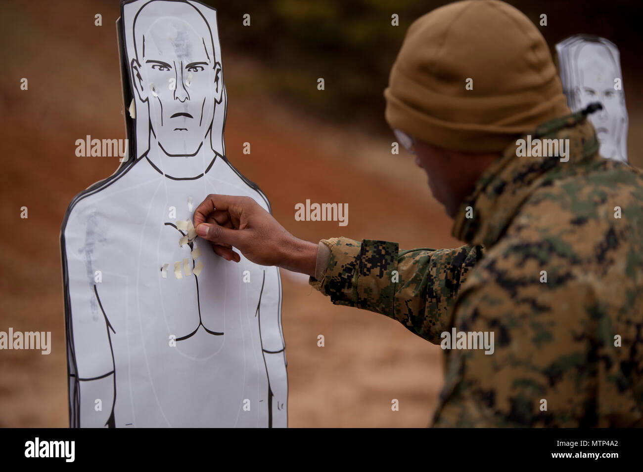 https://c8.alamy.com/comp/MTP4A2/us-marines-assigned-to-the-basic-school-pasties-up-his-target-after-conducting-the-combat-pistol-program-at-weapons-training-battalion-wtbn-aboard-mcb-quantico-va-jan-20-2017-the-purpose-of-wtbn-is-to-serve-as-the-marine-corps-proponent-for-all-facets-of-small-arms-combat-marksmanship-and-to-be-the-focal-point-for-marksmanship-doctrine-training-competition-equipment-and-weapons-us-marine-corps-photo-by-cpl-laura-mercado-MTP4A2.jpg