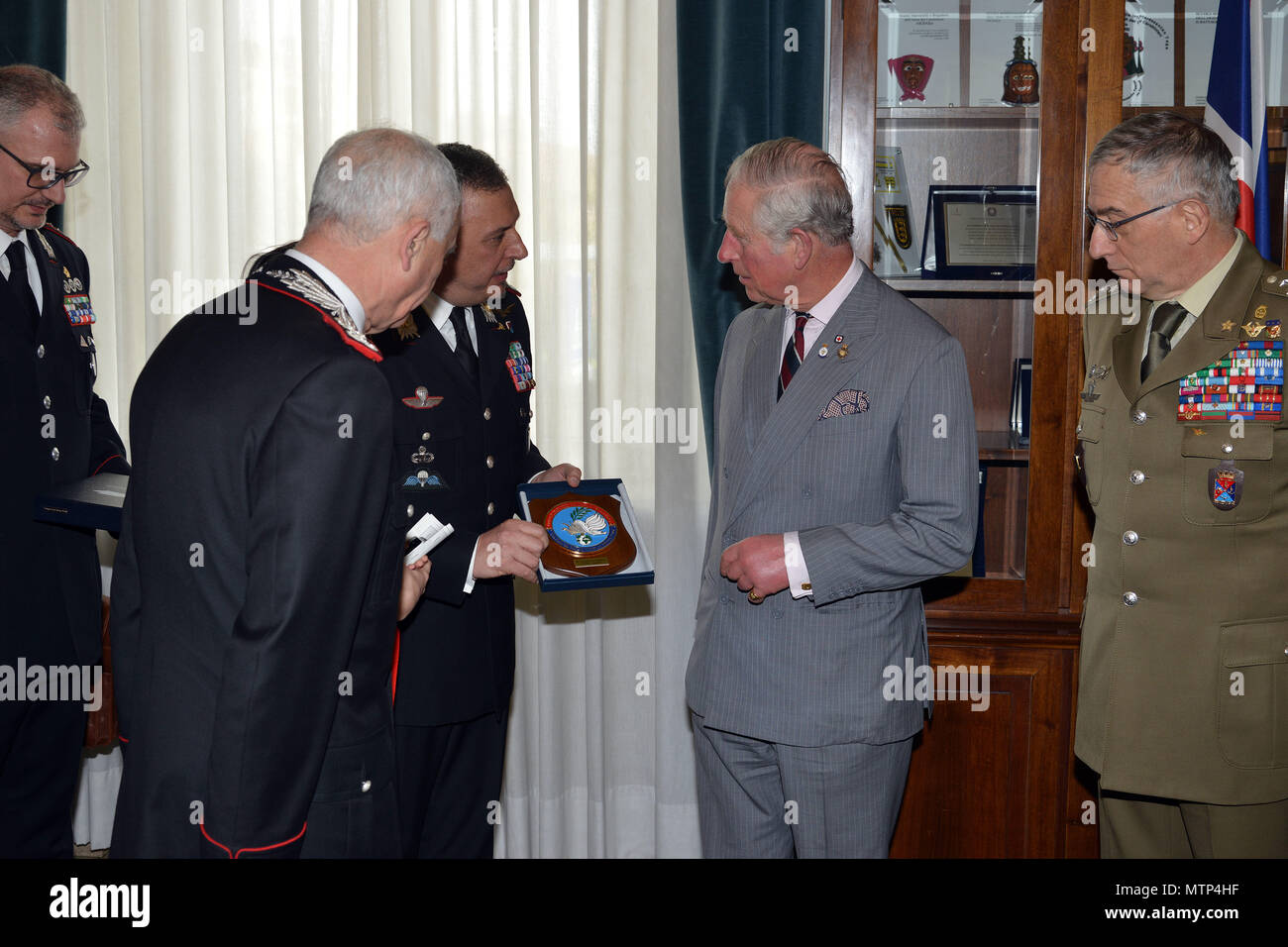 Brig. Gen. Giovanni Pietro Barbano, Center of Excellence for Stability Police Units (CoESPU) director (center), presents Carabinieri CoESPU crest to His Royal Highness, Prince Charles, Prince of Wales, during visit at Center of Excellence for Stability Police Units (CoESPU) Vicenza, Italy, April 1, 2017. (U.S. Army Photo by Visual Information Specialist Paolo Bovo/released) Stock Photo