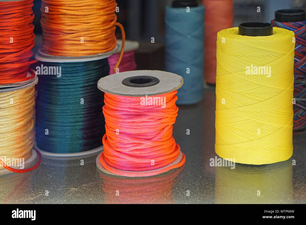 Colorful sewing threads and yarns at bobbins Stock Photo - Alamy