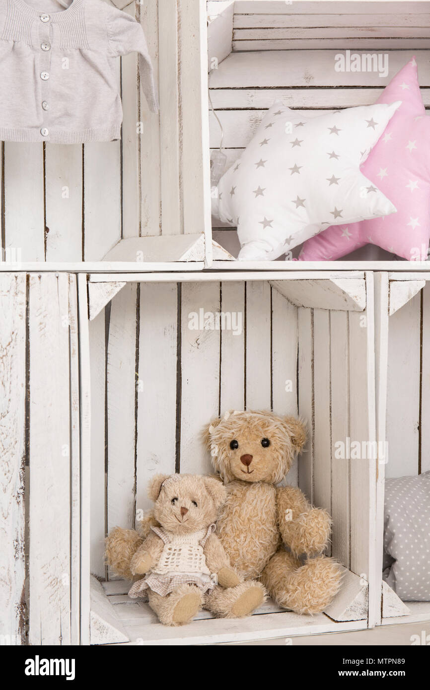 Shot of boxes with teddy bears and pillows in a baby room Stock Photo
