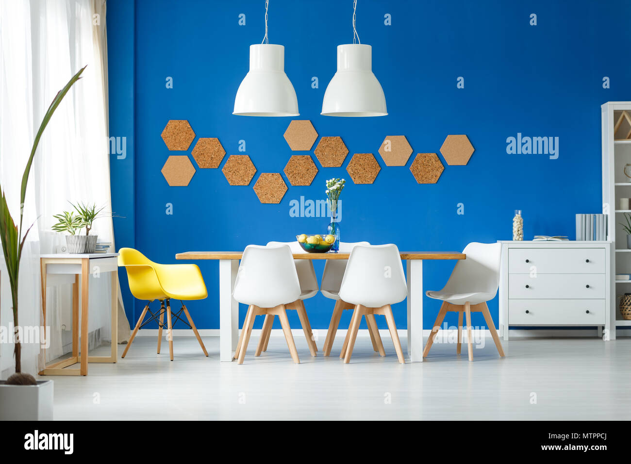 Modern trendy dining room with white scandinavian furniture, hexagon