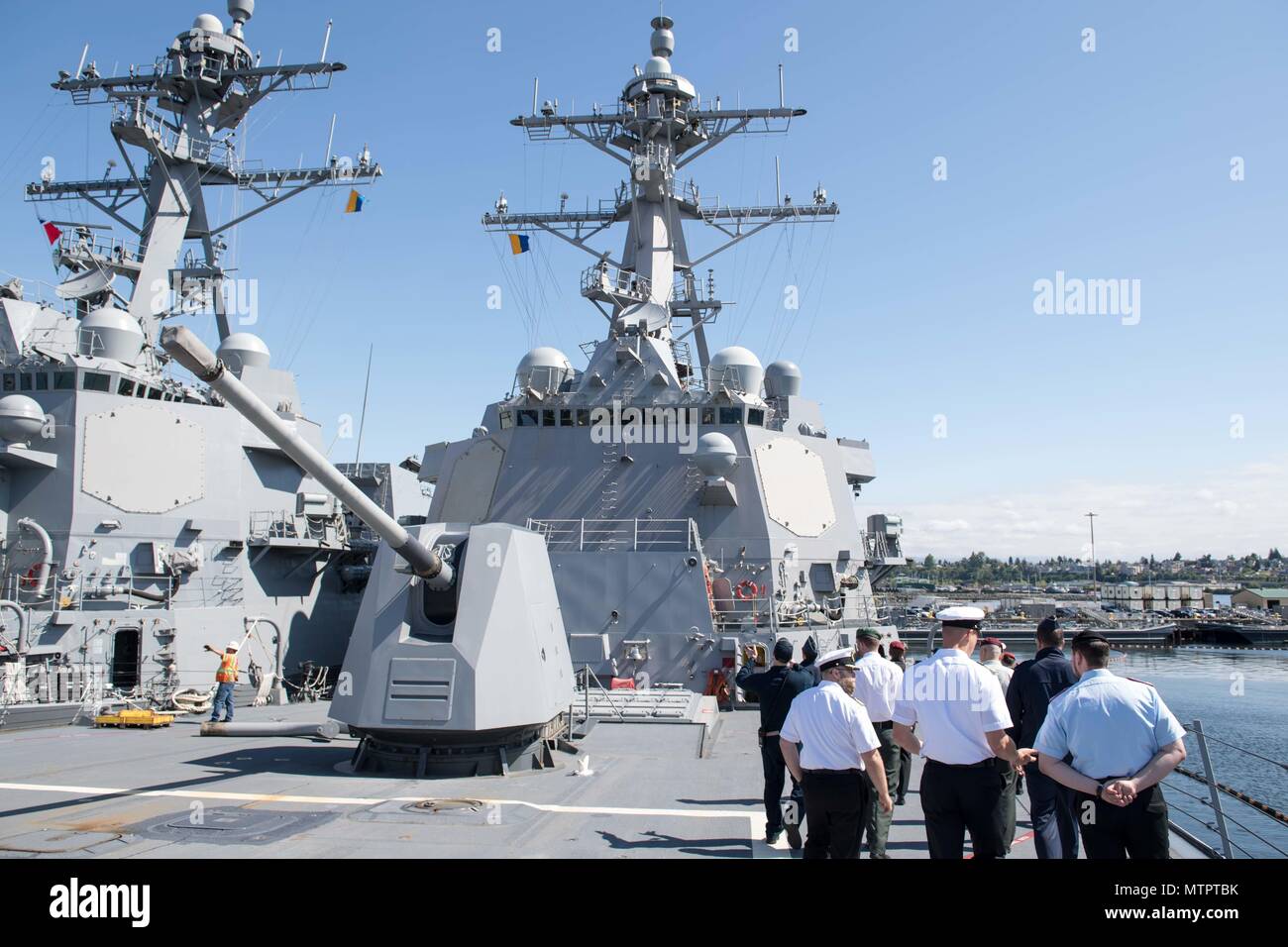 180521-N-DA737-0087 Everett, Wash. (May 21, 2018) Officers assigned to the Arleigh Burke-class guided-missile destroyer USS Gridley (DDG 101) give visiting German officers enrolled in the International General/Admiral Staff Officer Course (IGASOC) a tour of their ship. The tour is part of a visit by IGASOC students to Naval Station Everett. (U.S. Navy photo by Mass Communication Specialist 2nd Class Jonathan Jiang/Released) Stock Photo