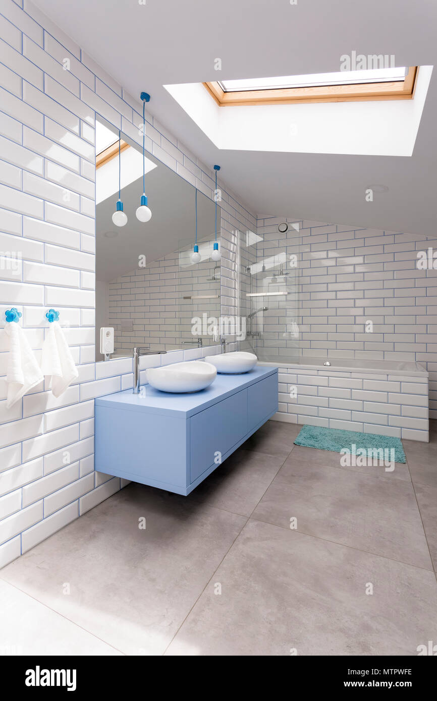 Blue Washbasin Cabinet And Mirror In Simple Bathroom With Glossy White Brick Wall Stock Photo Alamy
