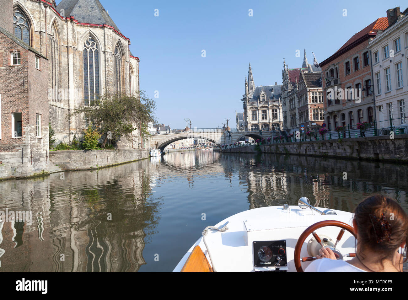 Belgium, Ghent, tourist tourboat along the riverside in the old town. Stock Photo