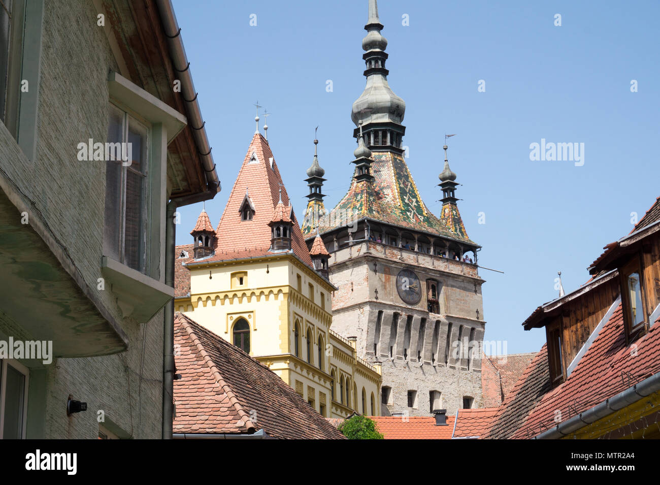 Street scene with historical clock tower Sighisoara Transivania Romania. Stock Photo