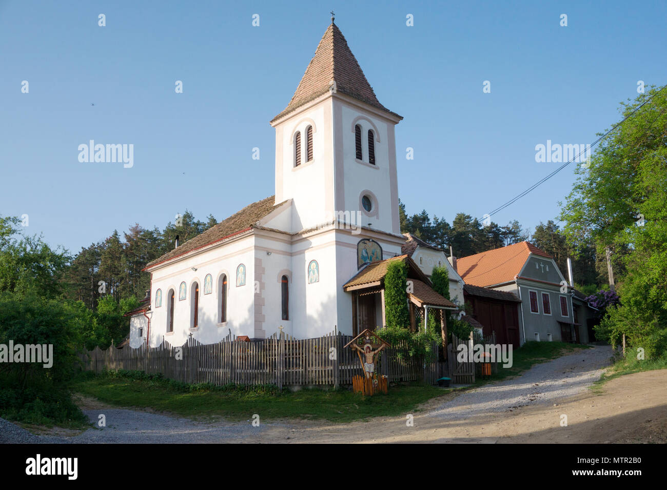 Scenic view of small church in UNESCO Heritage site Viscri with historical Saxon architecture Transilvania Romania Stock Photo