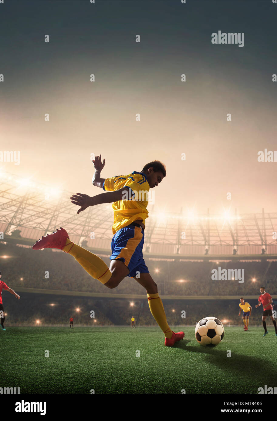 Football player shooting the ball at the goal. Stock Photo