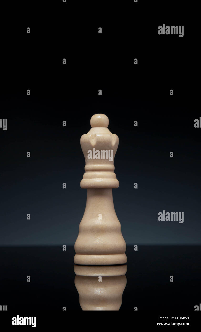 Chess queen, on gradient dark gray background. Portrait format. Stock Photo