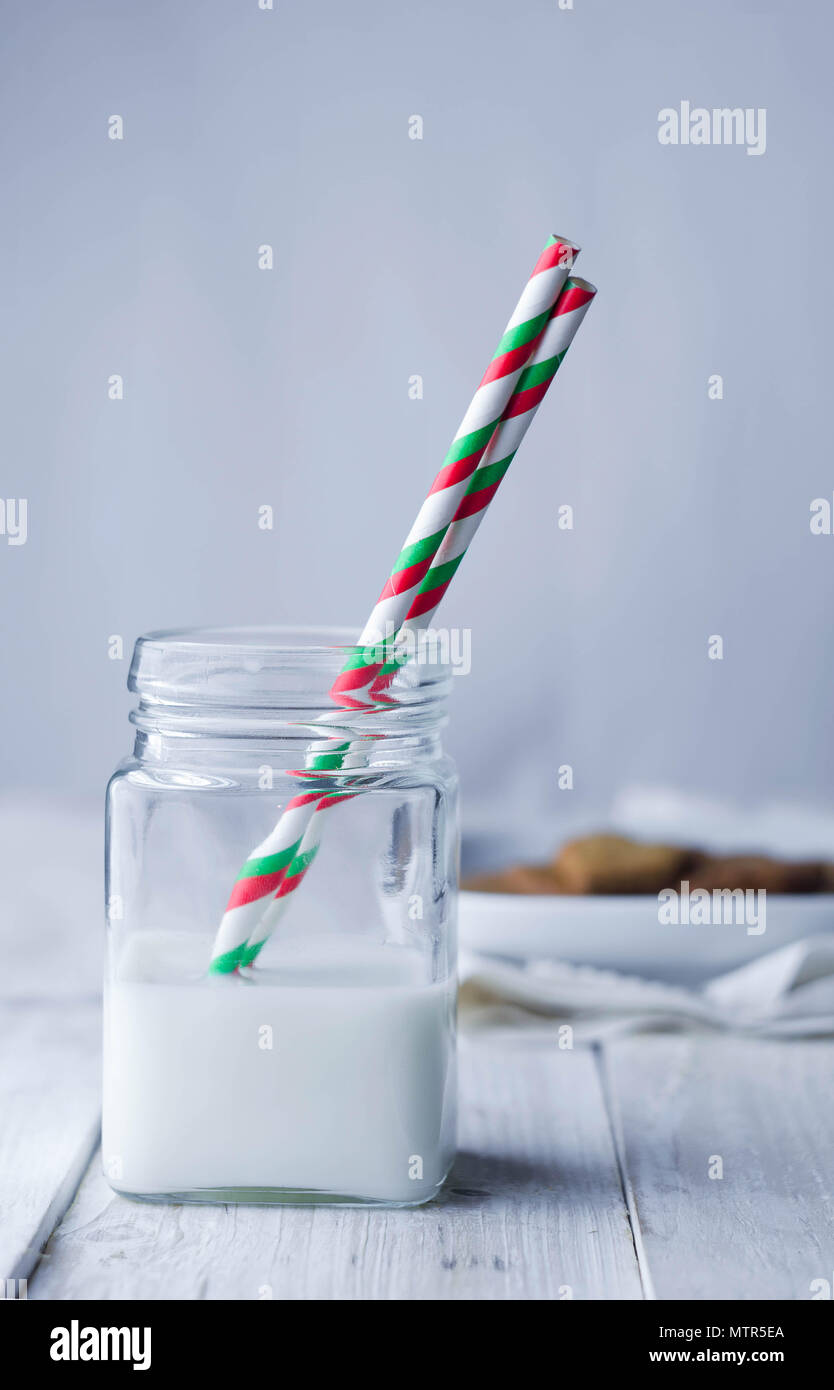 Violet glass cup with lid and straw on a white background isolated