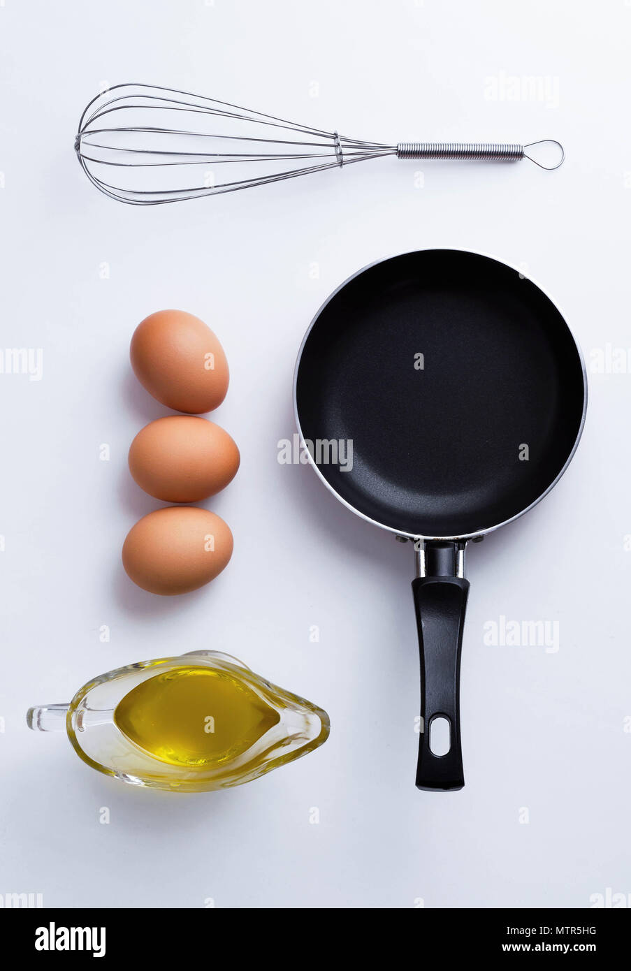 Scrambled eggs ingredients over white table, above view Stock Photo - Alamy