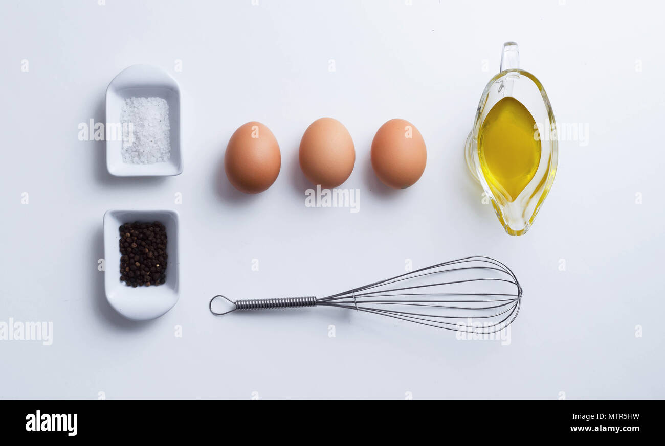 Scrambled eggs ingredients over white table, above view Stock Photo - Alamy