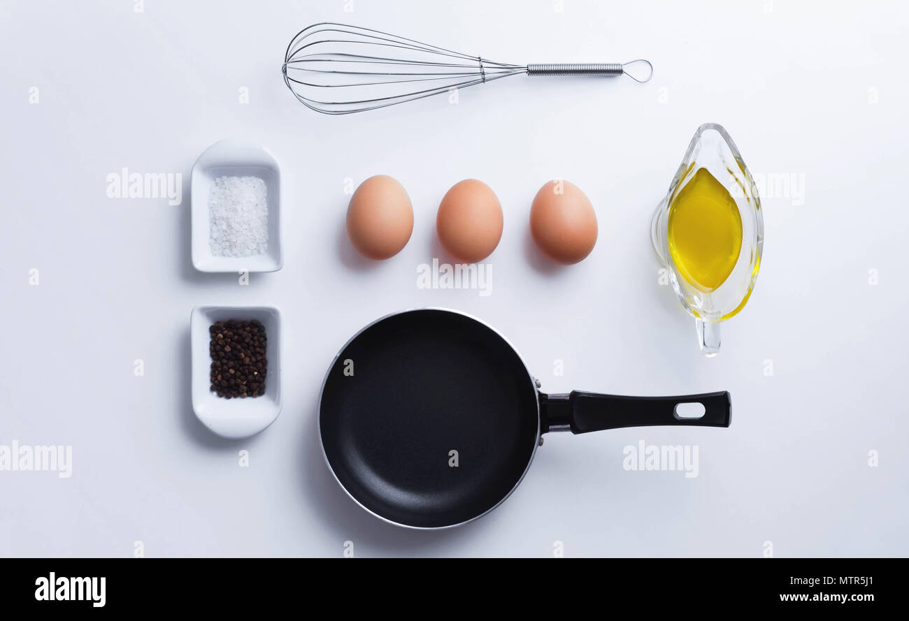 Scrambled eggs ingredients over white table, above view Stock Photo - Alamy