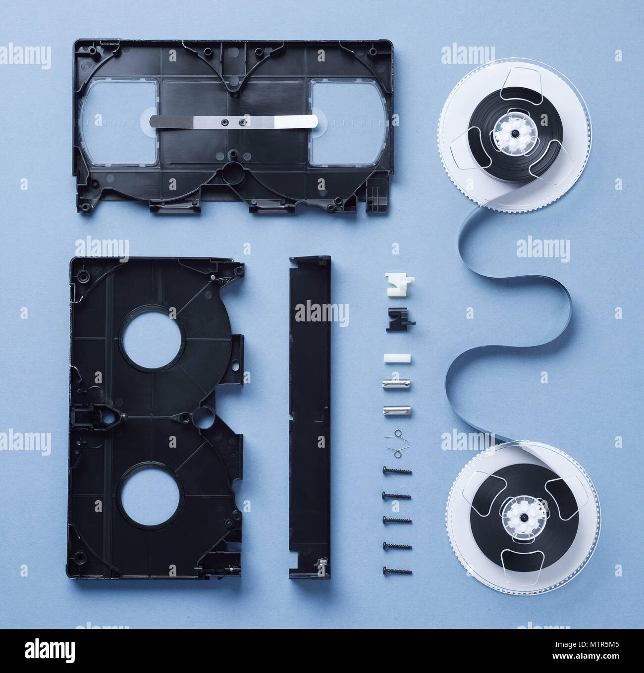 Components of a VHS Cassette disassembled and well arranged over blue  background Stock Photo - Alamy