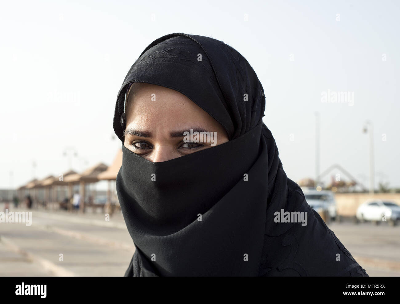 Saudi woman covered with hijab smiles for the camera Stock Photo
