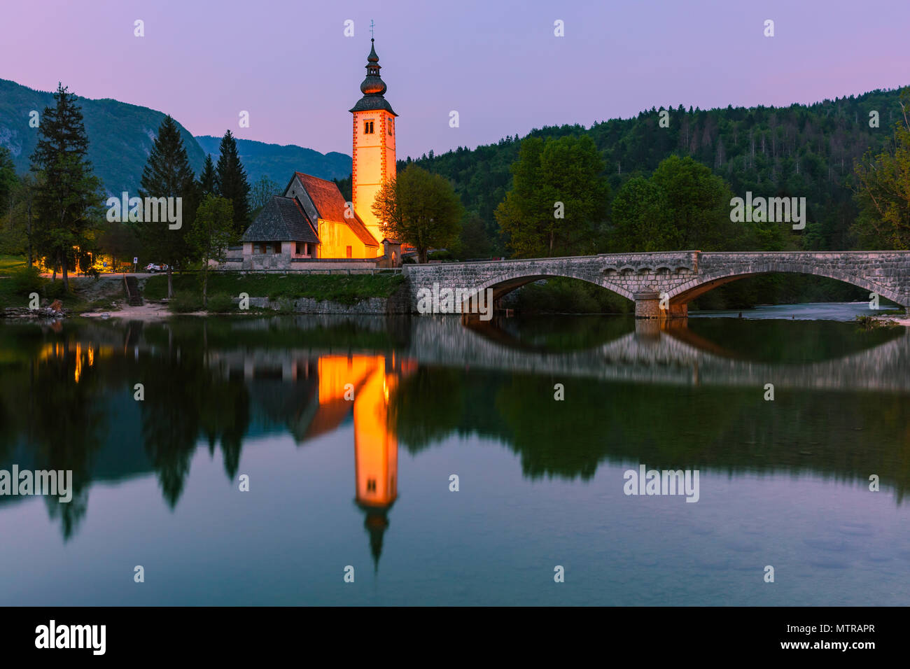 The church of St. John the Baptist at Lake Bohinj. Lake Bohinj is the ...