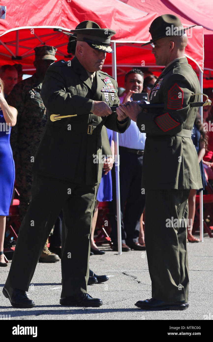 U.S. Marine Corps Brig. Gen. Austin E. Renforth, the Commanding General of Marine Corps Recruit Depot Parris Island (MCRD PI)/Eastern Recruiting Region (left), hands off a non-commissioned officer sword to Sgt. Maj. Rafael Rodriguez, the incoming Sergeant Major of MCRD PI/Eastern Recruiting Region, during a relief and appointment ceremony for the MCRD PI/Eastern Recruiting Region Sergeant Major at the General’s Building on MCRD PI, S. C., Jan. 13, 2017. Sgt. Maj. Angela M. Maness retired after 30 faithful years of service and was relieved of her duty as MCRD PI/Eastern Recruiting Region Sergea Stock Photo