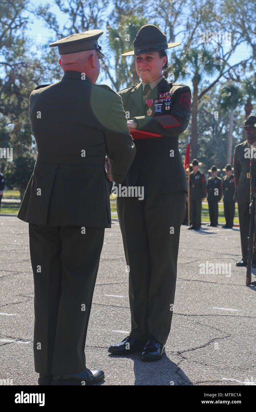 U.S. Marine Corps Brig. Gen. Austin E. Renforth, the Commanding General of Marine Corps Recruit Depot Parris Island (MCRD PI)/Eastern Recruiting Region (left), presents an award to Sgt. Maj. Angela M. Maness, the former Sergeant Major of MCRD PI/Eastern Recruiting Region, during the relief and appointment ceremony for the MCRD PI/Eastern Recruiting Region Sergeant Major at the General’s Building on MCRD PI, S. C., Jan. 13, 2017. Maness retired after 30 faithful years of service and was relieved of her duty as MCRD PI/Eastern Recruiting Region Sergeant Major by Sgt. Maj. Rafael Rodriguez. (U.S. Stock Photo