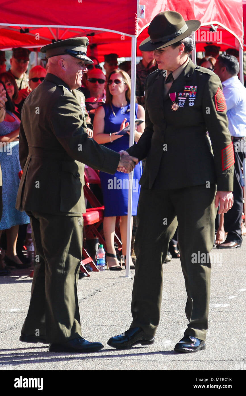U.S. Marine Corps Brig. Gen. Austin E. Renforth, the Commanding General of Marine Corps Recruit Depot Parris Island (MCRD PI)/Eastern Recruiting Region (left), shakes hands with Sgt. Maj. Angela M. Maness, the former Sergeant Major of MCRD PI/Eastern Recruiting Region, during the relief and appointment ceremony for the MCRD PI/Eastern Recruiting Region Sergeant Major at the General’s Building on MCRD PI, S. C., Jan. 13, 2017. Maness retired after 30 faithful years of service and was relieved of her duty as MCRD PI/Eastern Recruiting Region Sergeant Major by Sgt. Maj. Rafael Rodriguez. (U.S. Ma Stock Photo