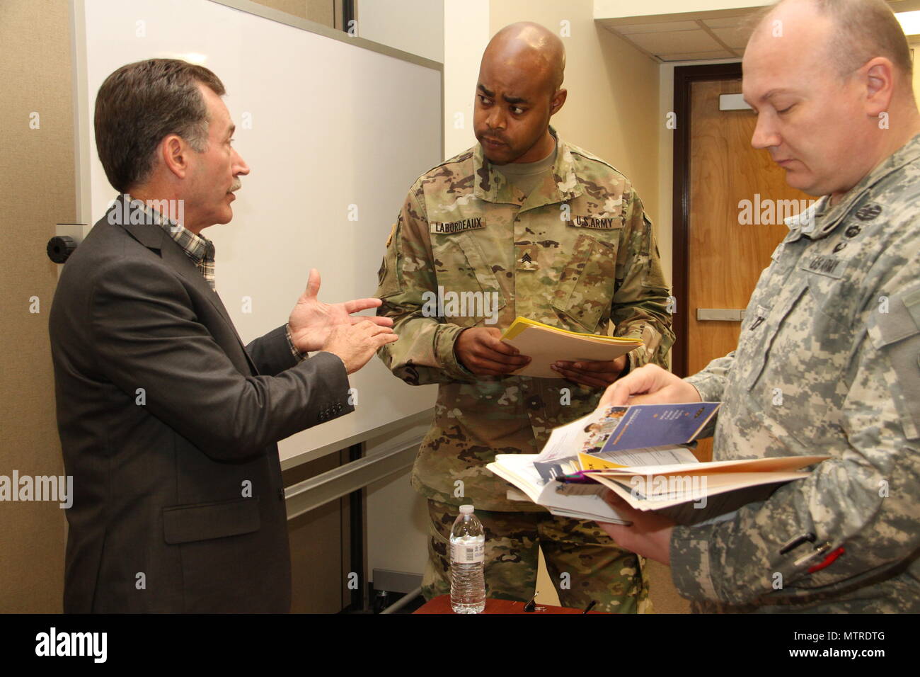 Employment Readiness Program Manager, Larry Keene, left, discusses