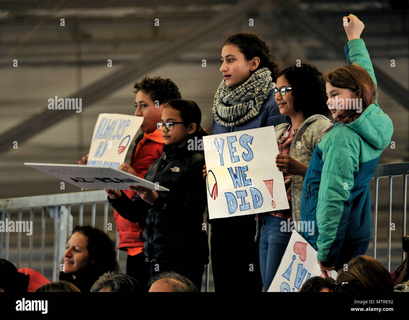 Children hold signs in support of former President Barack Obama during his farewell speech at Joint Base Andrews, Md. Jan. 20, 2017. After his speech Obama and his wife Michelle took time to shake hands and exchange hugs with members of the crowd before boarding a plane to depart. (U.S. Air Force photo by Staff Sgt. Stephanie Morris) Stock Photo