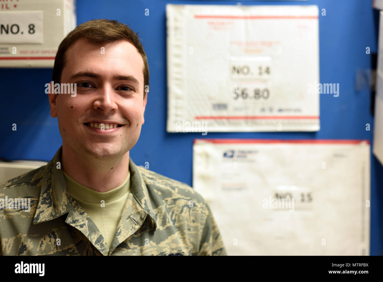 U.S. Air Force Senior Airman Jacob Franklin, a postal clerk with the 379th Expeditionary Communications Squadron post office, poses for a photo Al Udeid Air Base, Qatar, Jan. 19, 2016. The Al Udeid AB post office military control activity section works 365 days a year processing incoming and outgoing packages. (U.S. Air Force photo by Senior Airman Cynthia A. Innocenti) Stock Photo