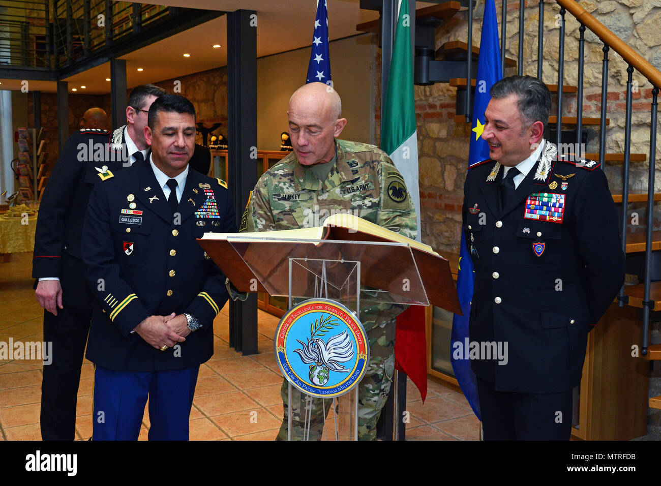 U.S. Army Col. Darius S. Gallegos (left), Center of Excellence for Stability Police Units (CoESPU) deputy director and Brig. Gen. Giovanni Pietro Barbano , (CoESPU) director, look Lt. Gen. Charles D. Luckey (center), Commanding General U.S. Army Reserve Command, sign the guestbook, during visit at Center of Excellence for Stability Police Units (CoESPU) Vicenza, Italy, January 20, 2017.(U.S. Army Photo by Visual Information Specialist Paolo Bovo/released) Stock Photo