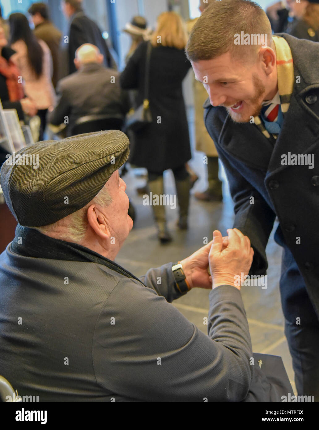 Former U.S. Army Spc. Kenneth Stumpf, Medal of Honor recipient and retired U.S. Marine Corps Cpl. William Kyle Carpenter, Medal of Honor recipient, exchange coins during a traditional Inaugural Day Medal of Honor breakfast held at the Reserve Officers Association headquarters in Washington D.C., January 20, 2017. (U.S. Army Reserve photo by Master Sgt. Marisol Walker/Released) Stock Photo