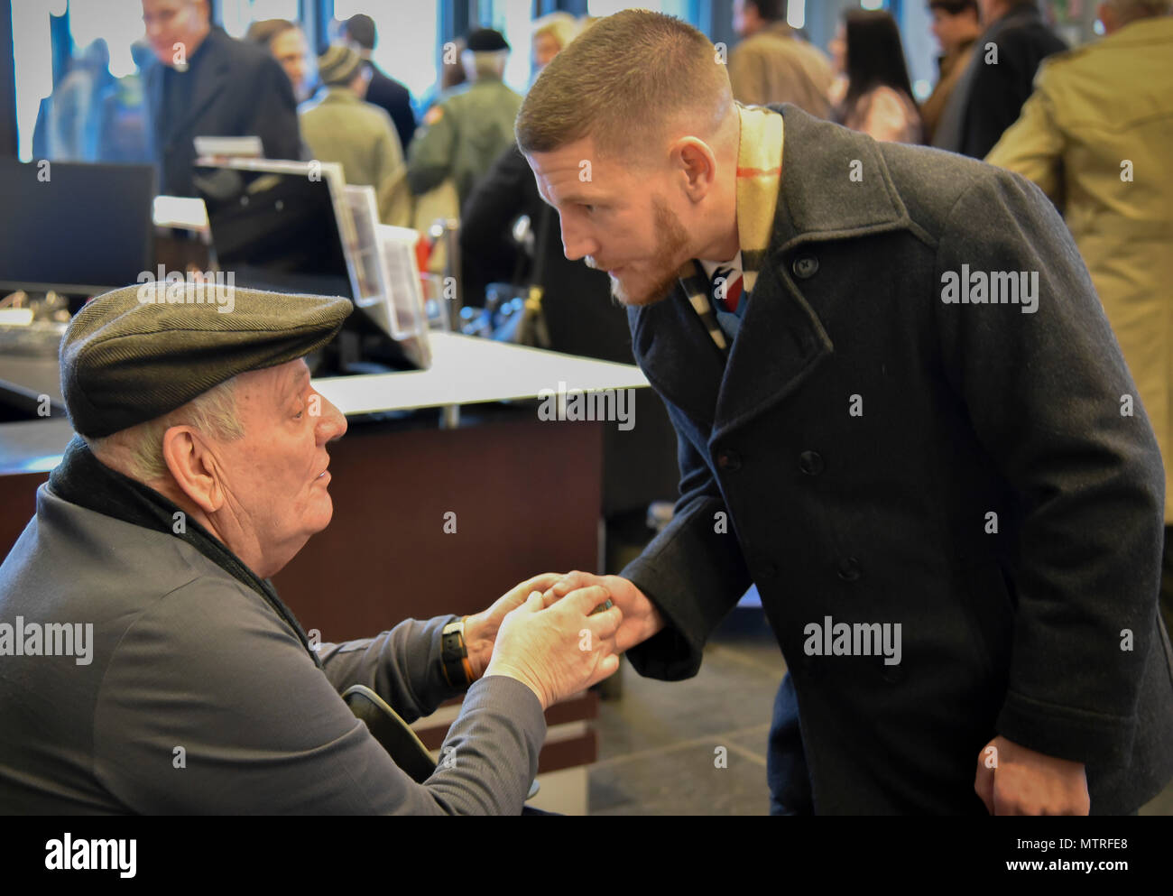 Former U.S. Army Spc. Kenneth Stumpf, Medal of Honor recipient and retired U.S. Marine Corps Cpl. William Kyle Carpenter, Medal of Honor recipient, exchange coins during a traditional Inaugural Day Medal of Honor breakfast held at the Reserve Officers Association headquarters in Washington D.C., January 20, 2017. (U.S. Army Reserve photo by Master Sgt. Marisol Walker/Released) Stock Photo