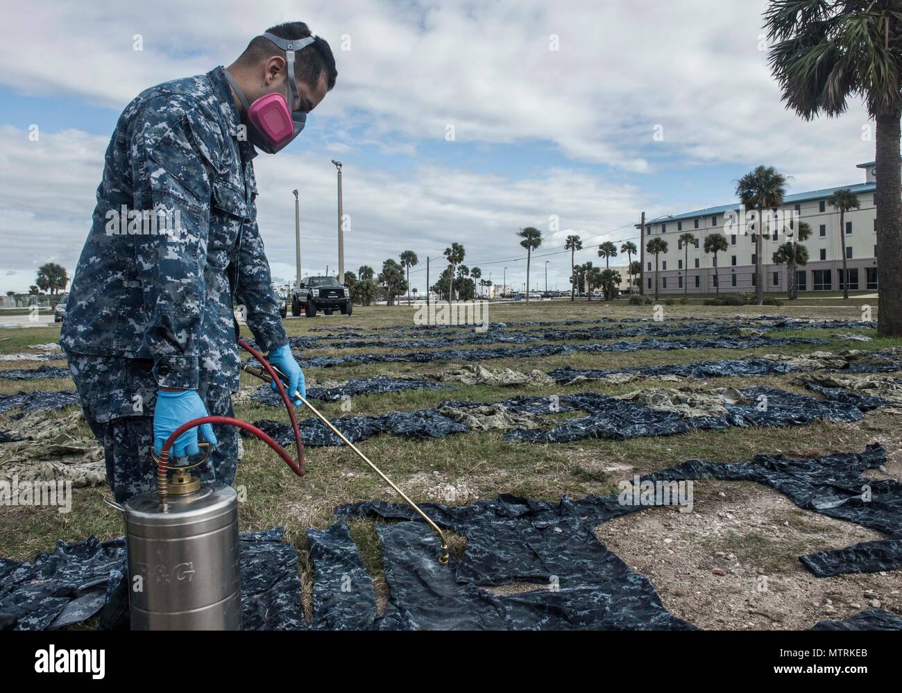 170123-WZ792-022 (Jan. 23, 2017) MAYPORT, Fla. - Hospital Corpsman 3rd Class Joshua Nieto of Navy Entomology Center of Excellence (NECE) Jacksonville, Fla.,  applies the insect repellant Permethrin to uniforms at Naval Station Mayport, Fla. Treating uniforms is one of many preparations  service members are taking before departing on Continuing Promise 2017 (CP-17). Continuing Promise 2017 is a U.S. Southern Command-sponsored and U.S. Naval Forces Southern Command/U.S. 4th Fleet-conducted deployment to conduct civil-military operations including humanitarian assistance, training engagements, an Stock Photo
