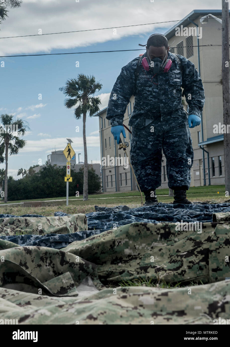 170123-WZ792-033 (Jan. 23, 2017) MAYPORT, Fla. - Hospital Corpsman 1st Class Dominic L'Admirault of Navy Entomology Center of Excellence (NECE) Jacksonville, Fla., applies the insect repellant Permethrin to uniforms at Naval Station Mayport, Fla. Treating uniforms is one of many preparations service members are taking before departing on Continuing Promise 2017 (CP-17). Continuing Promise 2017 is a U.S. Southern Command-sponsored and U.S. Naval Forces Southern Command/U.S. 4th Fleet-conducted deployment to conduct civil-military operations including humanitarian assistance, training engagement Stock Photo