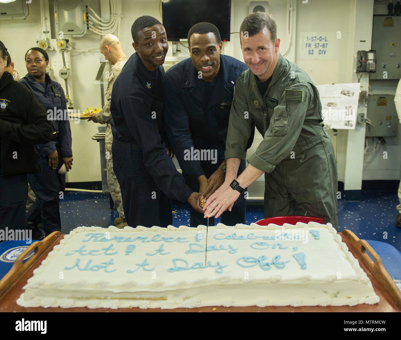 170117-N-LI768-143 ARABIAN SEA (Jan. 17, 2017) USS Makin Island (LHD 8)  Commanding Officer Capt. Mark A. Melson, right, is joined by Ship's  Serviceman 2nd Class Zemario Sheppard, from Sacramento, Calif., left, and