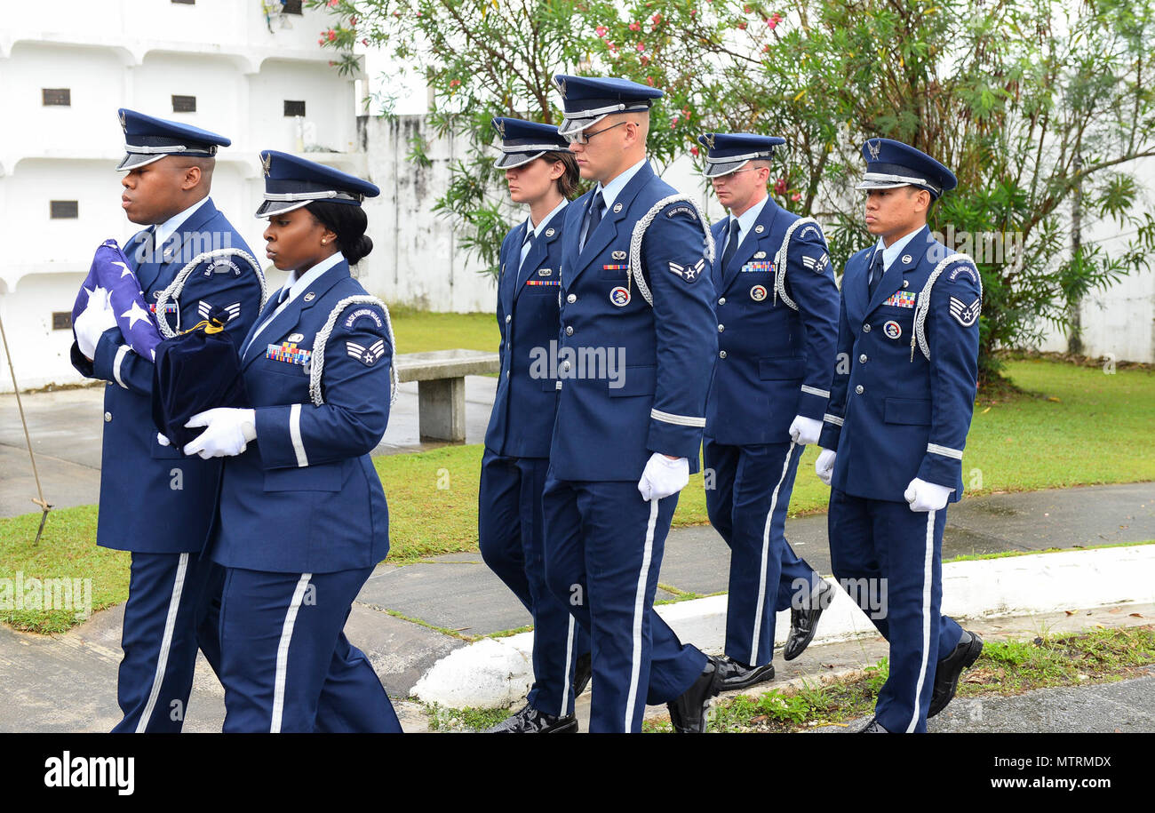 Honor Guard members with the 36th Wing ceremoniously carry Lt Col. (Ret.) Chuck McManus to his final resting place at the Guam Veterans Cemetery April 26, 2017, in Piti, Guam. McManus was directly involved with Linebacker II and he was the deputy director of plans at Andersen Air Force Base. Linebacker II was an intensive bombing campaign in December 1972 ordered by President Richard Nixon to persuade the North Vietnamese to return to the Paris peace talks. The campaign lasted 11 days, totaled more than 700 sorties and more than 15,000 tons of munitions were used Stock Photo