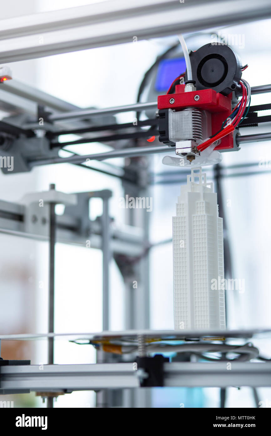 Close up of modern 3D printer creating skyscraper model Stock Photo