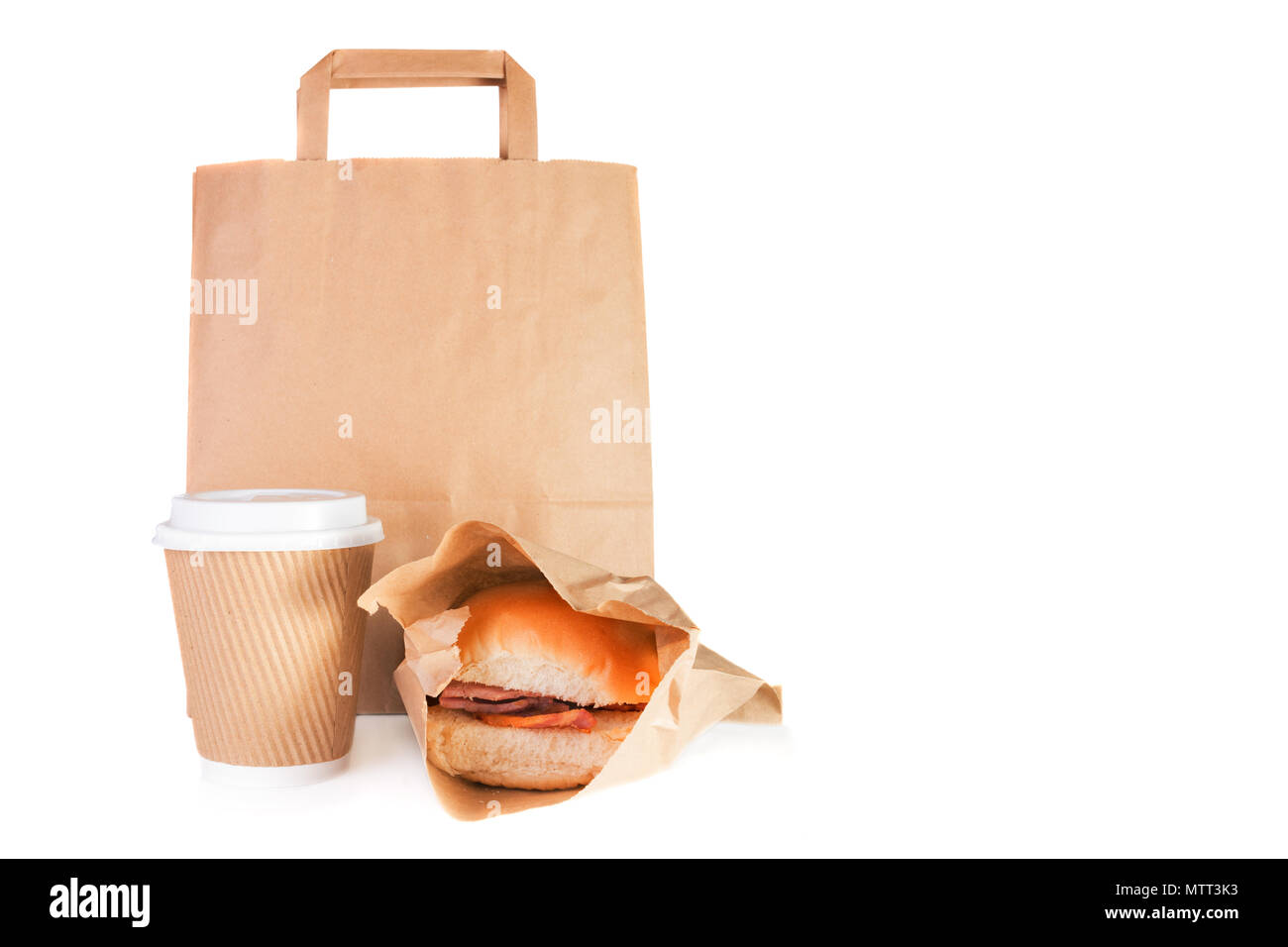 Brown paper carrier bag, take away paper cup, bacon roll in a take away wrap Stock Photo